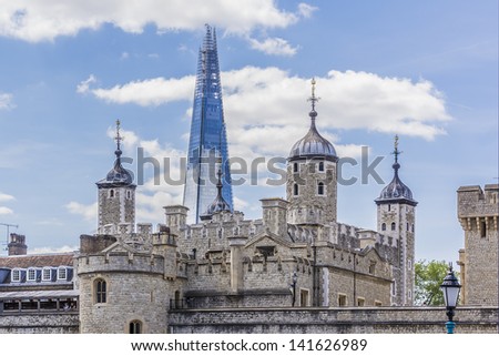 LONDON - JUNE 03: View of Tower of London & Shard (Architect Renzo Piano, 2012) - tallest building in European Union on June 03 2013, London. Glass-clad pyramidal tower (310 m) has 72 habitable floors