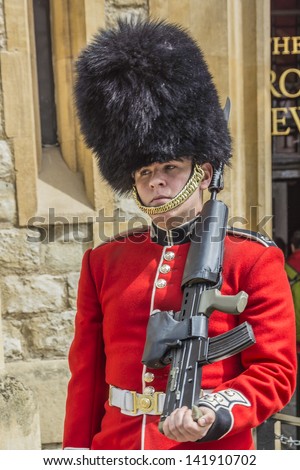 LONDON - MAY 26: Guard in Castle Tower of London on May 26, 2013, London, UK. British Guards in red uniforms are among the most famous in the world.