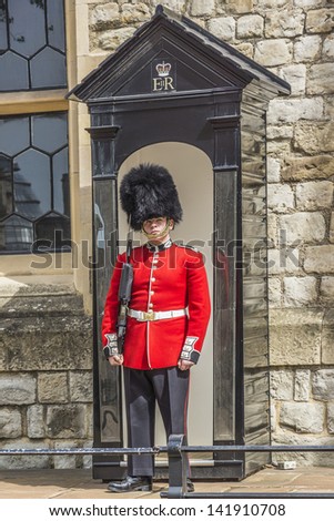 LONDON - MAY 26: Guard in Castle Tower of London on May 26, 2013, London, UK. British Guards in red uniforms are among the most famous in the world.