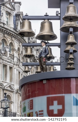 LONDON, UK Ã¢Â?Â? MAY 31: View of Swiss glockenspiel clock (erected 1985) on Leicester Square, on May 31, 2013 in London, UK. Under the clock have 27 bells and figures of traditional Swiss Alpine farmers.