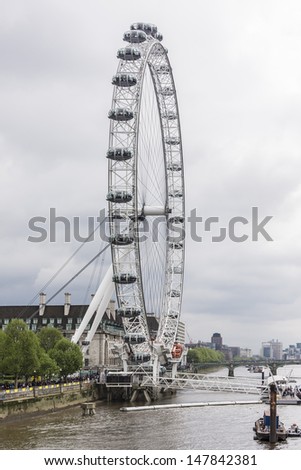 LONDON - MAY 30: View of the London Eye on May 30, 2013 in London, England. London Eye (135 m tall, diameter of 120 m) - a famous tourist attraction over river Thames in the capital city London.