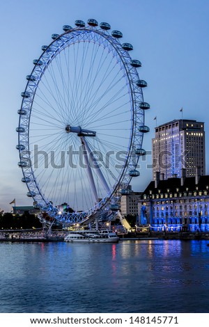 LONDON - JUNE 3: View of the London Eye at night, on June 3, 2013 in London, England. London Eye - a famous tourist attraction over river Thames in the capital city London.