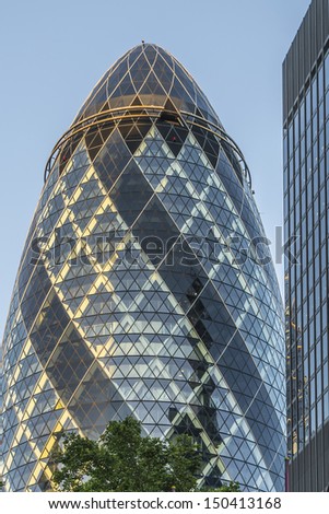 LONDON - JUNE 3: View of Gherkin building (30 St Mary Axe) at sunset in London on June 3, 2013. Gherkin - iconic symbol of London, one of city\'s most widely recognized examples of modern architecture.