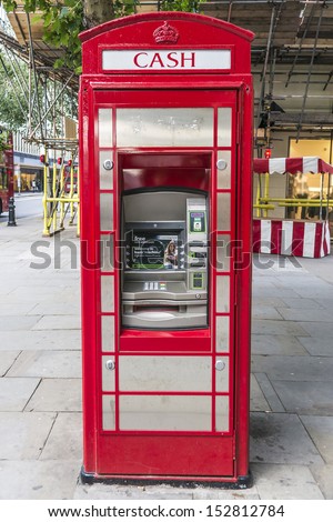 LONDON - MAY 25: Traditional Iconic red telephone box but with ATM, on May 25, 2013, London.