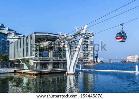 LONDON, UK - MAY 30, 2013: View of Emirates Air Line (or Thames cable car) - cable car link Greenwich Peninsula and Royal Dock across River Thames. Service opened on June 2012.
