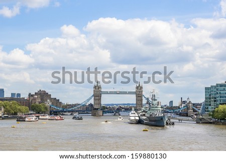 LONDON, UK - MAY 25, 2013: View of HMS Belfast (Royal Navy light cruise) in background of Tower bridge. Belfast moored in London on River Thames and operated by Imperial War Museum.