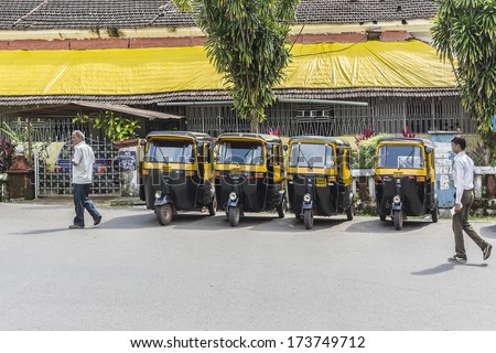 PANJIM, GOA, INDIA - SEPTEMBER 30, 2013: Auto rickshaw (tuk-tuk) taxis on a road. Auto rickshaws running on natural gas in an effort to reduce pollution.