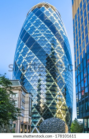 LONDON - JUNE 3, 2013: View of Gherkin building (30 St Mary Axe) at sunset in London. Gherkin - iconic symbol of London, one of city\'s most widely recognized examples of modern architecture.