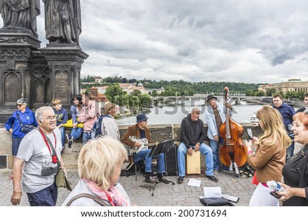 PRAGUE, CZECH REPUBLIC - JUNE 20, 2014: Unknown street musicians on Charles Bridge. Charles Bridge is a popular tourist attraction in Prague. On the bridge you can find many street musicians.