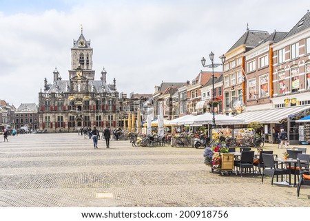 DELFT, NETHERLANDS - JUNE 17, 2013: Old houses and restaurant on the Markt (central square) of Delft, Holland.