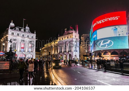 LONDON, UK - MARCH 17, 2013: Famous Piccadilly Circus neon signage shines at rainy night. These signs have become a major attraction of London, United Kingdom