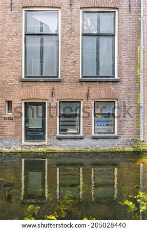 Houses reflected in water canal in the centre of the city Delft. The Netherland.
