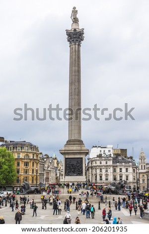 LONDON - MAY 30, 2013: Tourists visit Trafalgar Square in London. Trafalgar Square - the largest square in London, is often considered the heart of London.