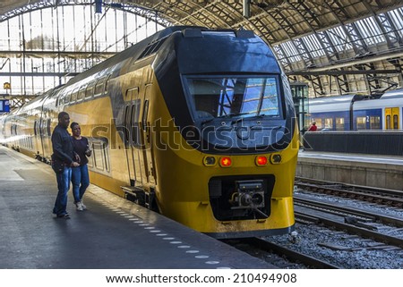 AMSTERDAM, NETHERLANDS - JUNE 18, 2014: Interior of Amsterdam Central Train Station (Amsterdam Centraal). Central Station is central railway station of Amsterdam, is used by 250,000 passengers a day.