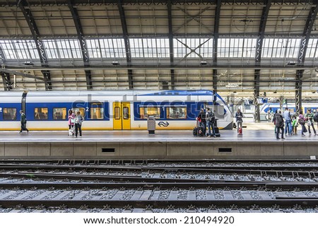AMSTERDAM, NETHERLANDS - JUNE 18, 2014: Interior of Amsterdam Central Train Station (Amsterdam Centraal). Central Station is central railway station of Amsterdam, is used by 250,000 passengers a day.
