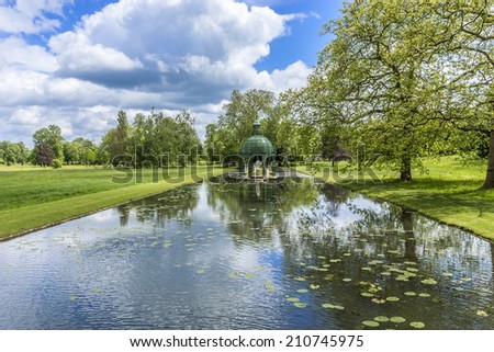 The Island of Love in English Garden (Jardin Anglais, 1817). Famous Chateau de Chantilly (Chantilly Castle, 1560) - historic chateau located in town of Chantilly, Oise, Picardie, France.
