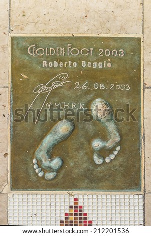 MONACO - JULY 8, 2014: Winner of Golden Foot award (international prize awarded to footballers) leaves a permanent mould of his footprints on \