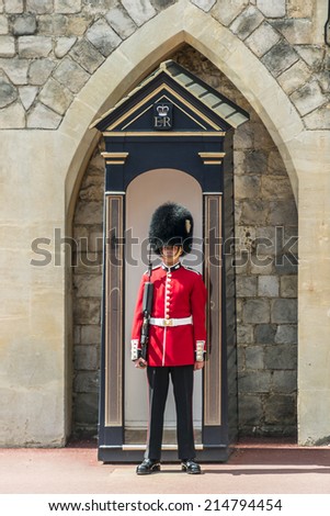 WINDSOR, ENGLAND - MAY 27, 2013: Changing Guard takes place in Windsor Castle. British Guards in red uniforms are among the most famous in the world.