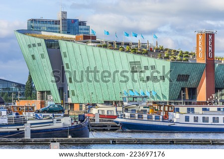 AMSTERDAM, NETHERLANDS - JUNE 17, 2014: Science Center NEMO designed by Renzo Piano (1997) - largest children\'s science educational museum, knowledge institute and center of tourism in Netherlands.