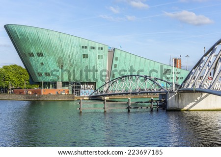 AMSTERDAM, NETHERLANDS - JUNE 17, 2014: Science Center NEMO designed by Renzo Piano (1997) - largest children's science educational museum, knowledge institute and center of tourism in Netherlands.