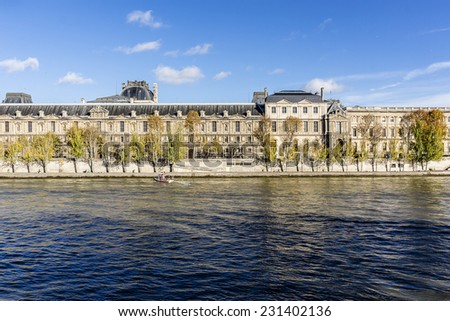 PARIS, FRANCE - NOVEMBER 12, 2014: View of famous Louvre Museum from the Seine river. Louvre Museum is one of the largest and most visited museums worldwide.