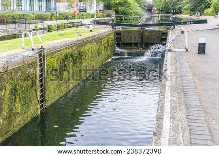 Regent's Canal. London, England. The Regent's Canal forms a junction with the old Grand Junction Canal at Little Venice, a short distance north of Paddington Basin.