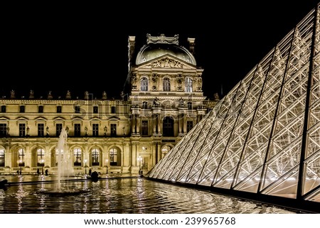 PARIS, FRANCE - NOVEMBER 12, 2014: Night view of famous pyramid in Louvre Museum courtyard. Louvre Museum is one of the largest and most visited museums worldwide.