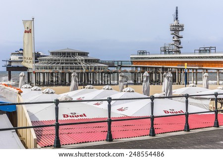 HAGUE, NETHERLANDS - JUNE 17, 2014: View of Scheveningen pier (1959, 382 meter long concrete pier). Pier was officially opened by Prince Bernhard in 1961. Scheveningen is one of eight Hague districts.