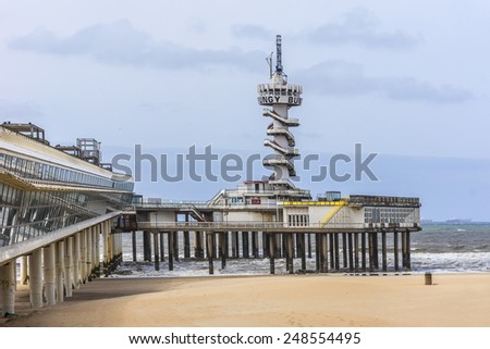 HAGUE, NETHERLANDS - JUNE 17, 2014: View of Scheveningen pier (1959, 382 meter long concrete pier). Pier was officially opened by Prince Bernhard in 1961. Scheveningen is one of eight Hague districts.
