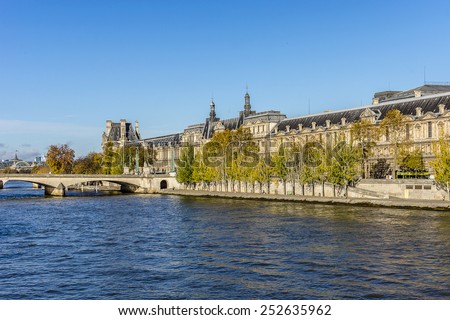 PARIS, FRANCE - NOVEMBER 12, 2014: View of famous Louvre Museum from the Seine river. Louvre Museum is one of the largest and most visited museums worldwide.