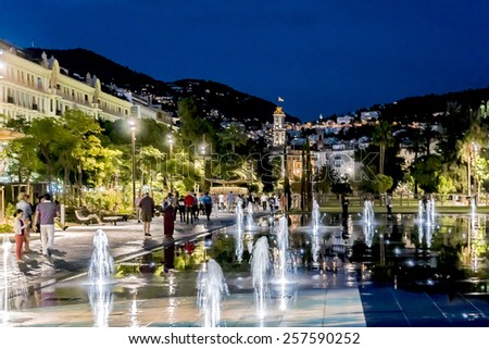 NICE, FRANCE - JULY 7, 2014: Famous Fountain on Place Massena at night. Place Massena - Main Square of the city and it is used for concerts and other events which take place in the city.