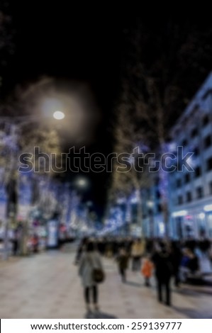 Blurred background: Illuminated Avenue Champs-Elysees. Paris, France.