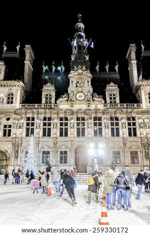 PARIS, FRANCE - DECEMBER 22, 2014: Skating near Hotel de Ville (City Hall, 1874 -1882, architects Theodore Ballou and Edouard Deperta). Building housing City of Paris\'s administration.