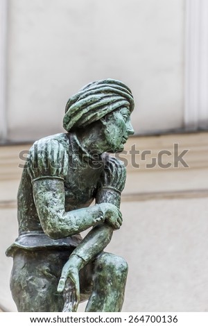 A bronze statue of a poor student near St Mary\'s Basilica - a replica of Wit Stwosz (German sculptor, Veit Stoss) sculptures in famous gothic altar of Basilica (Kosciol Mariacki). Kracow, Poland.