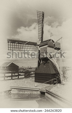 Traditional Dutch old wooden windmill in Zaanse Schans - museum village in Zaandam. The Netherlands. Antique vintage.