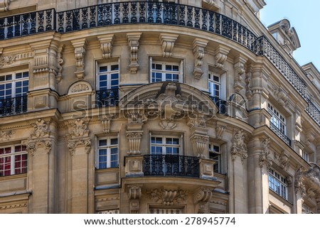 Old French house with traditional balconies and windows. Paris, France.