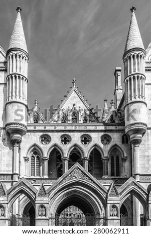 Royal Courts of Justice in the Victorian Gothic style (Law Courts, designed by George Edmund Street, was opened by Queen Victoria in December 1882) in London, UK. Black and white.