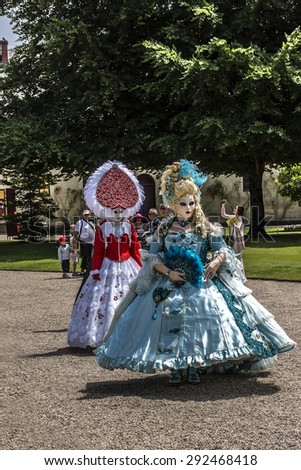 CHEVERNY, FRANCE - JUNE 10, 2015: Venetian carnival (costume party) enthusiasts, dressed in colorful costumes, masks and feathers, have animated the field of Cheverny.
