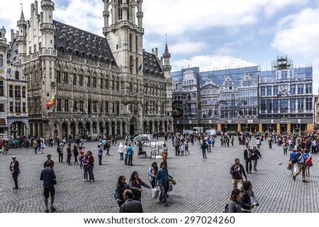 BRUSSELS, BELGIUM - JUNE 19, 2014: Many tourists visiting area of famous Grand Place (Grote Markt) - the central square of Brussels. Grand Place was named by UNESCO as a World Heritage Site in 1998.