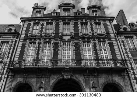 Place des Vosges - oldest planned square in Paris, in Marais district. Place des Vosges was built by Henri IV from 1605 to 1612. Black and white.
