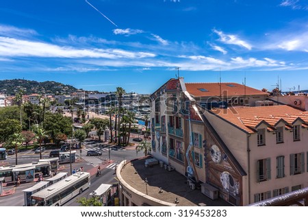 CANNES, FRANCE - JULY 7, 2014: Cannes cityscape. Cannes - a resort in southern France: many flowers and palm, luxury boutiques and restaurants, cafes, luxurious hotels - all for leisure travelers.