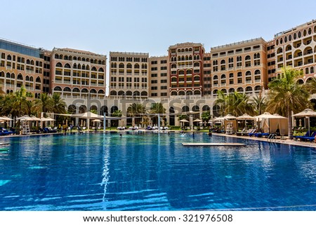 ABU DHABI, UNITED ARAB EMIRATES - SEPTEMBER 5, 2015: Swimming pool in 5 stars Hotel Ritz-Carlton Abu Dhabi, Grand Canal (532 rooms, gardens with private beach, pool, gym and 10 restaurants).