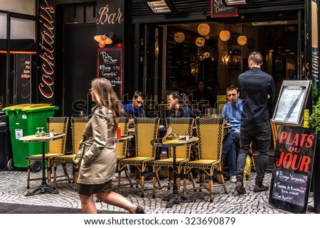 PARIS, FRANCE - JUNE 2, 2015: View of Rue Montorgueil - street in Montorgueil-Saint Denis-Les Halles district of Paris. Street is full of restaurants, cafes, bakeries, cheese shops, flower shops.