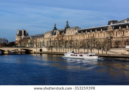 PARIS, FRANCE - DECEMBER 16, 2015: View of famous Louvre Museum from the Seine river. Louvre Museum is one of the largest and most visited museums worldwide.