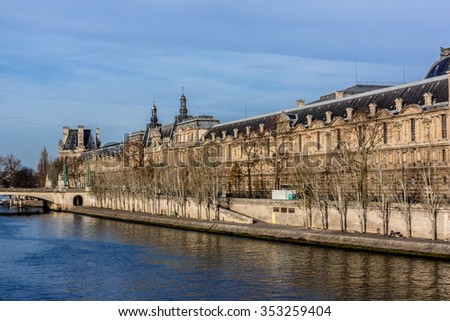 PARIS, FRANCE - DECEMBER 16, 2015: View of famous Louvre Museum from the Seine river. Louvre Museum is one of the largest and most visited museums worldwide.