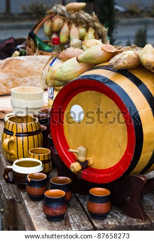 wood barrel with cups and food ornaments