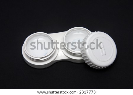 Contact Lens case with contact lens inside against black background