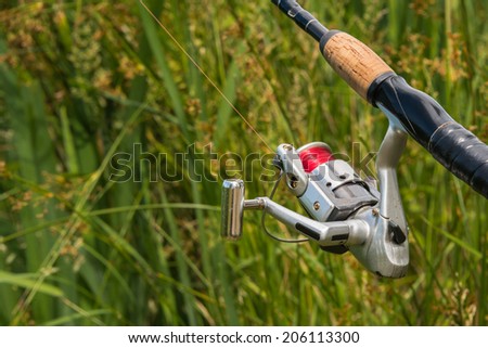 Sports Fishing Pole Rod Reel Close Up. Copy space.
