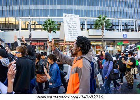 LOS ANGELES, CA - DEC 13, 2014: Justice for Blacks Protest hands up and sign listing Ezell Ford, Eric Garner, Michael Brown and other Blacks killed by police, Hollywood, Los Angeles, CA, Dec 13, 2014.