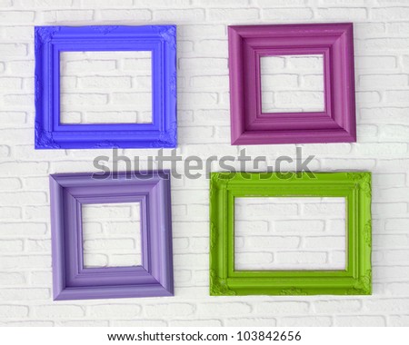 four photo frames on the white wall